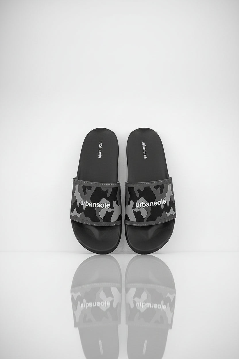 Pair of black and gray camouflage slide sandals with 'urbansole' branding on a white background