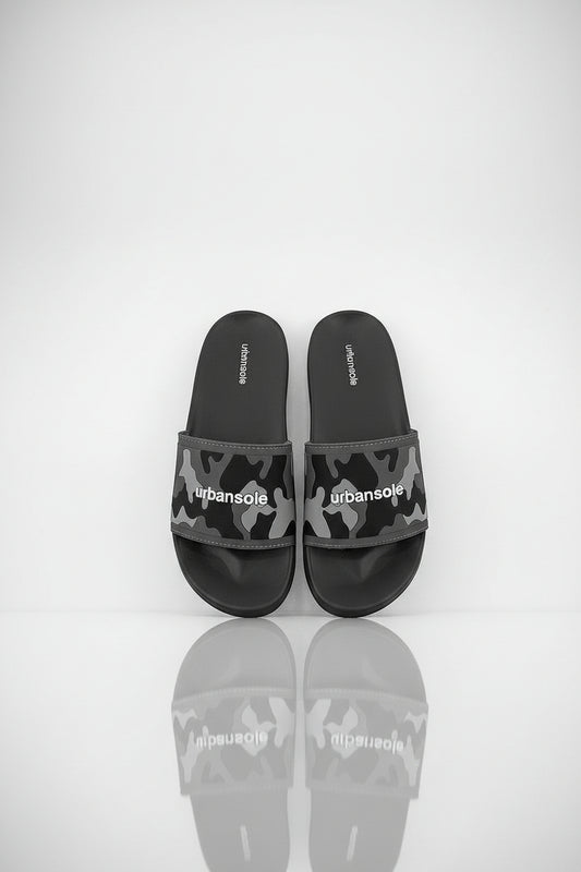 Pair of black and gray camouflage slide sandals with 'urbansole' branding on a white background