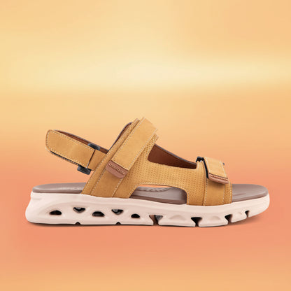 Tan sandal with a white sole on a light gray background
