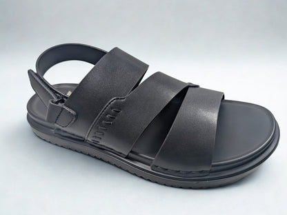 Black sandal with multiple straps on a light gray background