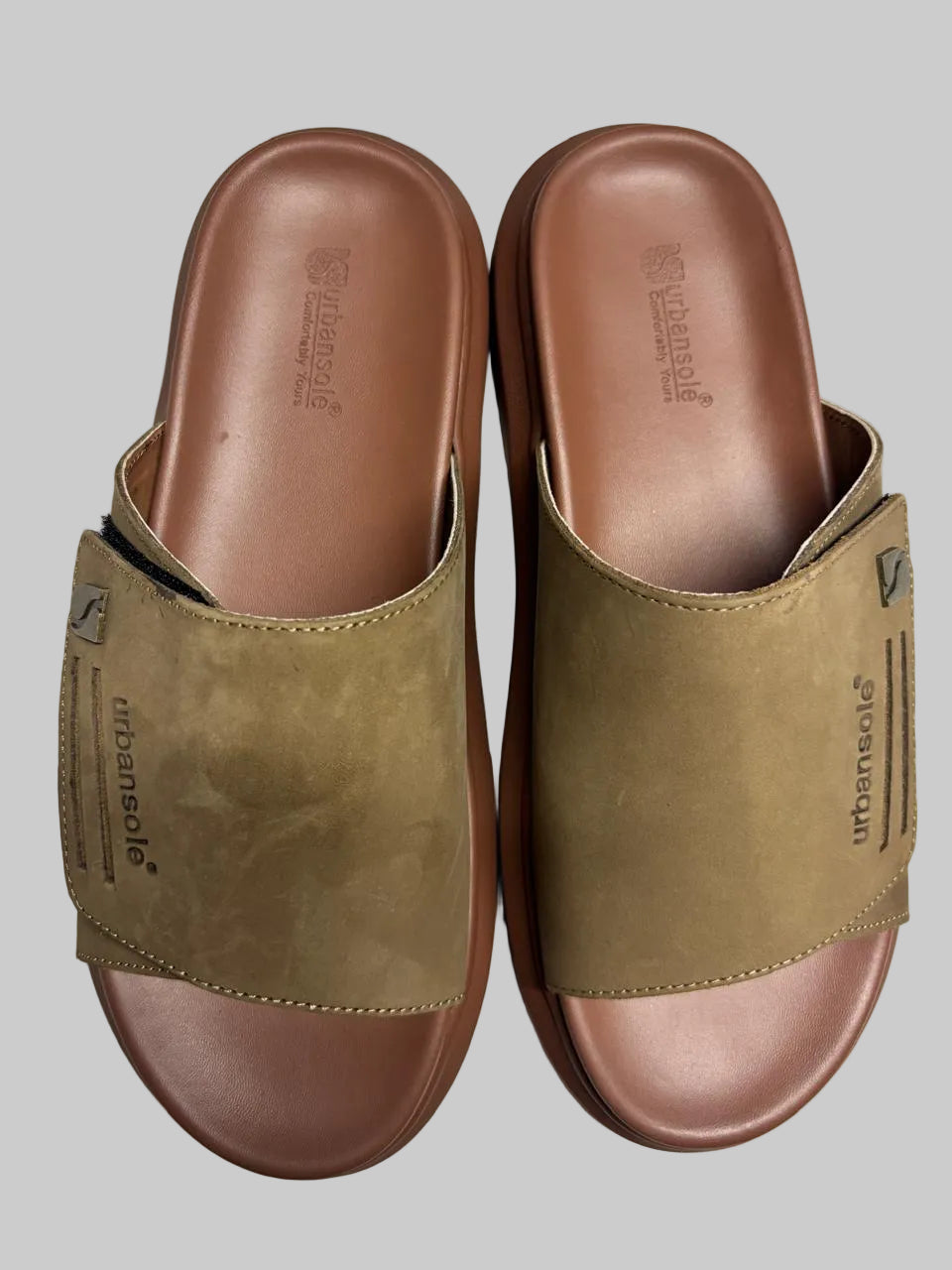 Pair of brown sandals with a visible brand logo on a white background