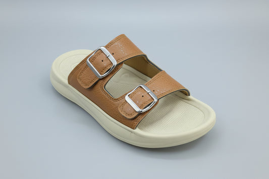 Brown sandal with silver buckles on a gray surface
