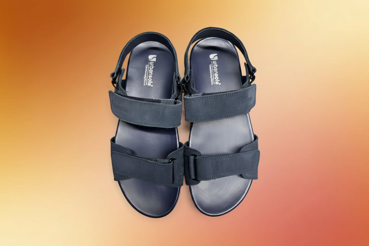 Pair of navy sandals with 'Urban Outfitters' branding on a white background