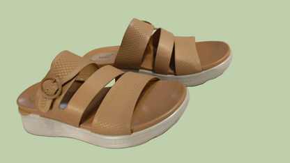 Pair of brown sandals on a tiled floor