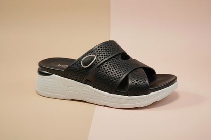 Black sandal with white sole on a beige background