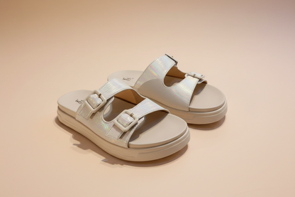 Beige sandals with buckles on a light background