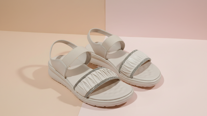 White sandals with decorative straps on a light background
