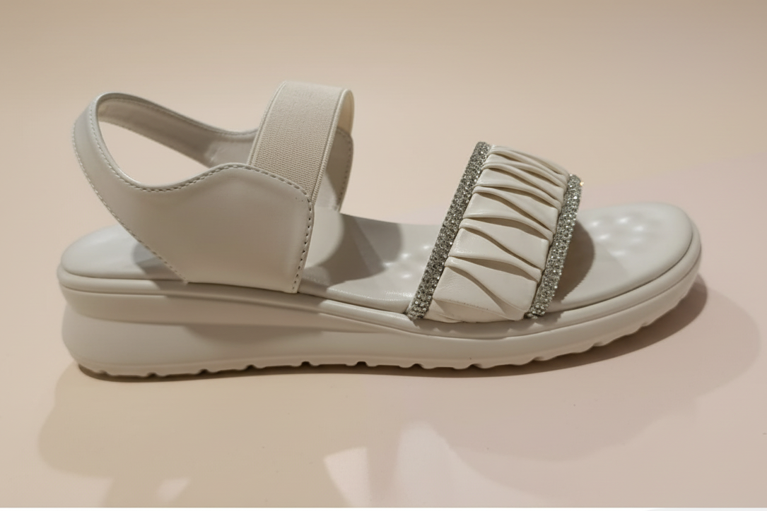 Beige sandal with a platform sole on a white surface
