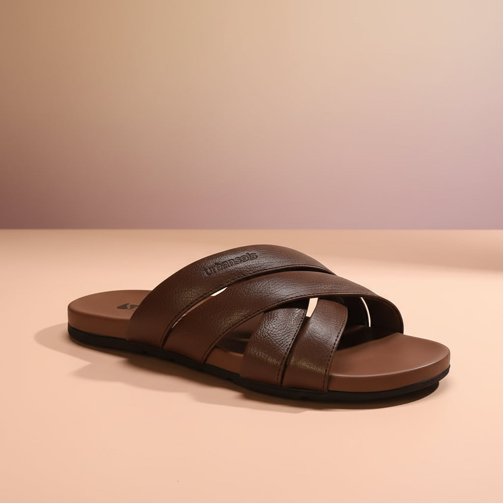 Brown sandal with criss-cross straps on a white background