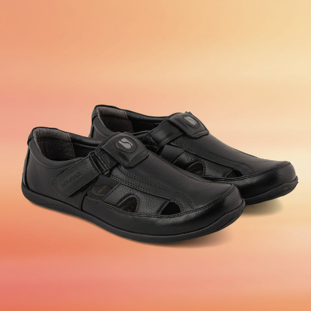 Pair of black sandals with velcro straps on a white background