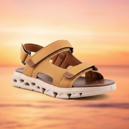 Tan sandal with a white sole on a light gray background