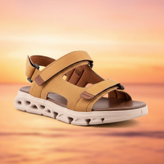 Tan sandal with a white sole on a light gray background