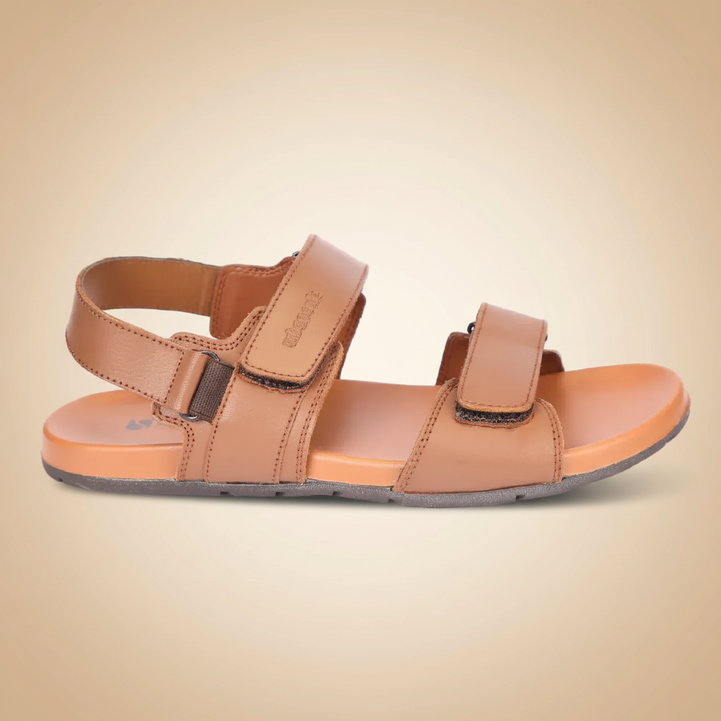 Tan sandal with velcro straps on a beige background